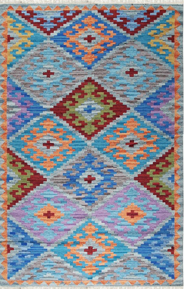 A vibrant flatweave rug displaying geometric diamond patterns in shades of blue, orange, purple, and gray.
