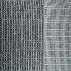 Flatweave rug detail featuring a vertical stripe panel in dark gray next to a contrasting white open weave area.