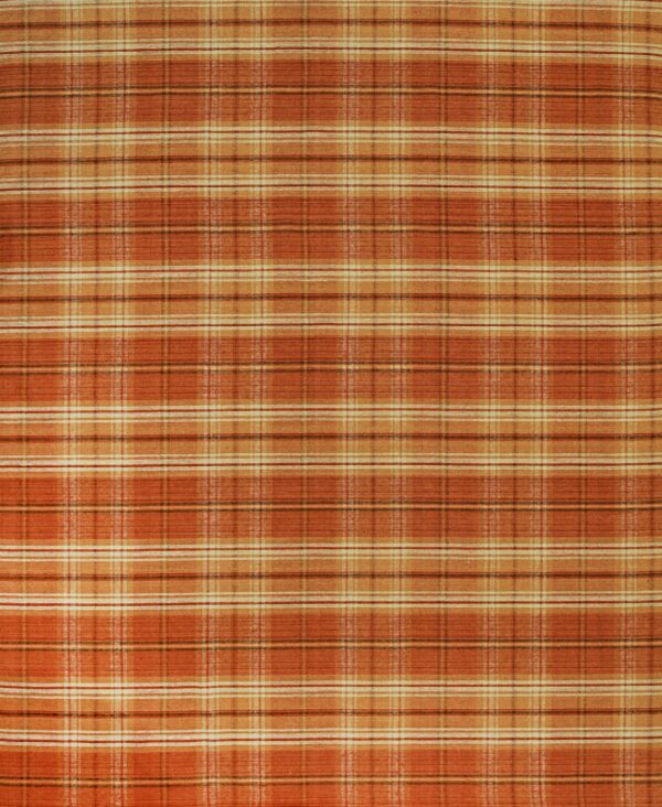 A low-pile rug featuring an orange, rust, and cream tartan plaid pattern.