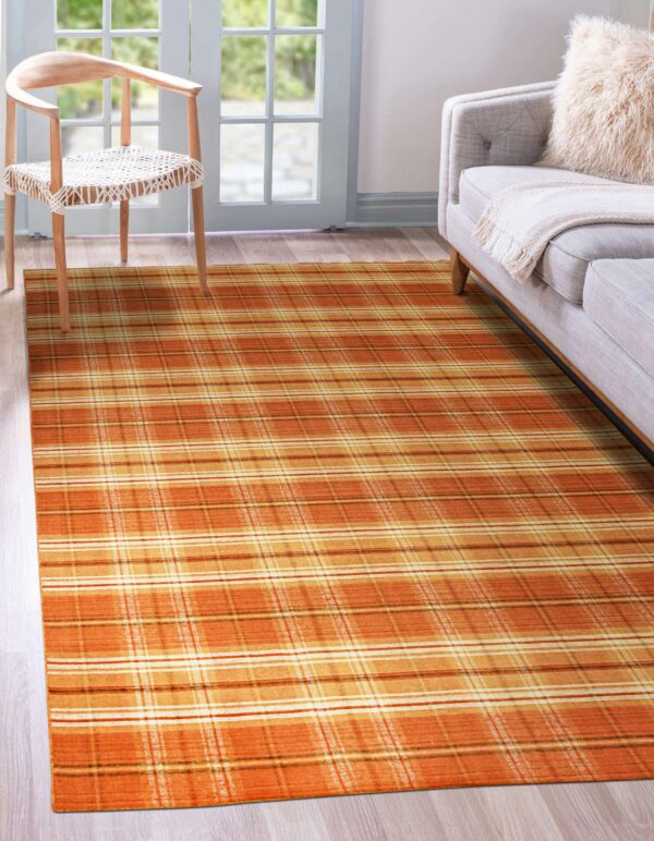 Low-pile orange and yellow plaid area rug beside a gray sofa and woven wooden chair.