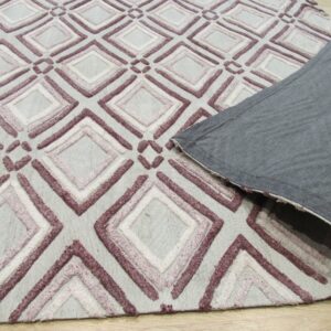Low pile rug with textured mauve and white geometric diamonds on a light gray base; corner is folded showing gray backing.