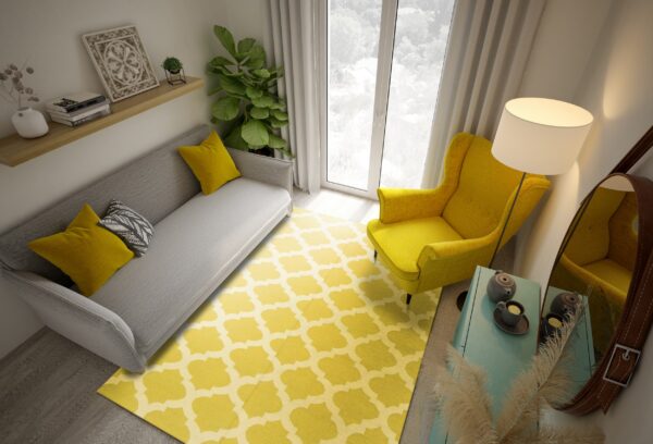 Bright yellow quatrefoil rug under a gray sofa and matching yellow armchair in a modern room.