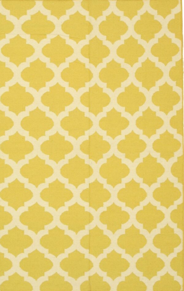 Flatweave rug with a bright yellow and cream geometric quatrefoil pattern.
