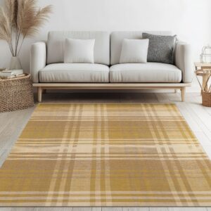 Yellow and cream plaid area rug in front of a neutral sofa on white plank floors.