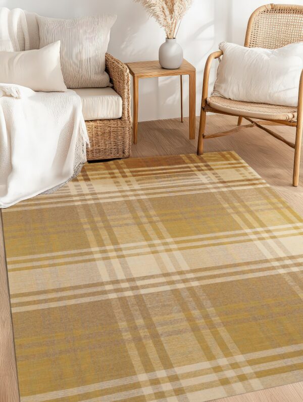 Gold and beige plaid area rug on wood flooring next to a wicker chair and sofa.