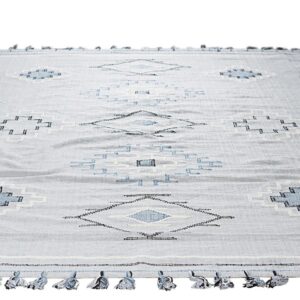 Light gray flatwoven rug featuring a geometric pattern of blue and white diamonds and blue edge tassels.