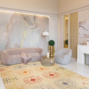 Beige flat weave rug with colorful geometric medallions defines a contemporary living room with velvet seating.