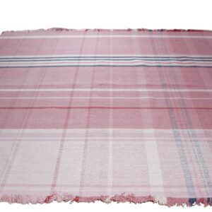 Pink and white flatweave rug with a plaid stripe design and short fringe on the ends.