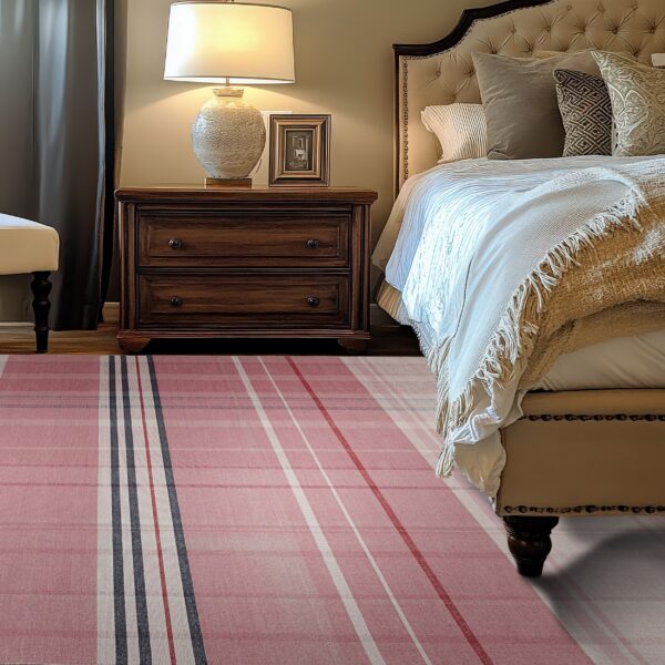 Pink, white, and gray plaid rug lies on hardwood floors next to a dark wood nightstand and tufted bed.