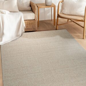 Textured beige rug placed on light wood flooring between wicker seating and a small wooden side table.
