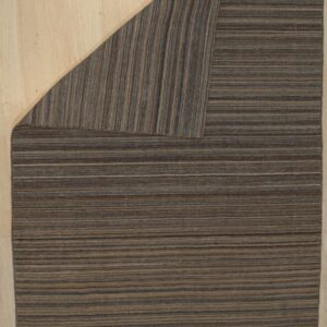 Brown and tan striped rug on a light wood floor with the upper corner folded back.
