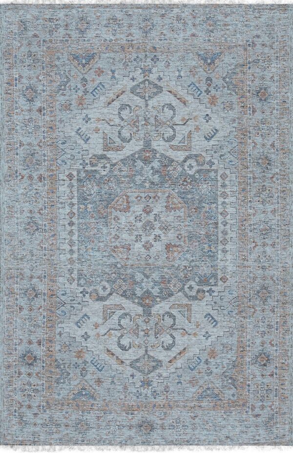A low-pile distressed rug featuring a traditional medallion pattern in light blue, navy, charcoal, and rust tones, with short fringe.