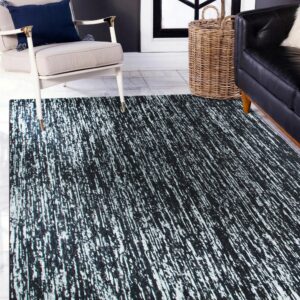 A black rug with distressed white vertical streaks is placed between a cream chair and black leather couch.