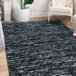 Abstract black rug featuring distressed horizontal light blue lines rests on a wood floor in a corner setting.