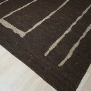 Dark brown low-pile rug with thick light beige geometric lines rests on pale wood flooring.