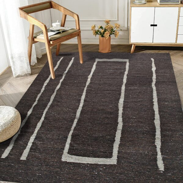 Textured brown rug featuring wide gray abstract stripes and a rectangle in a sunlit room setting.