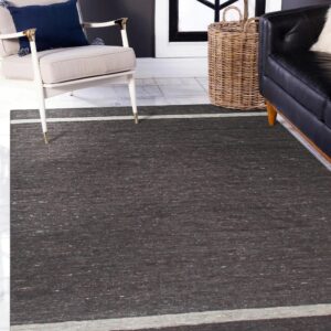 Dark brown mottled rug with light beige stripes on the ends, set on white tile flooring.