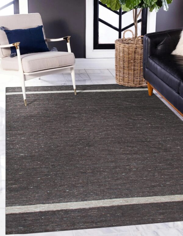 Dark brown mottled rug with light beige stripes on the ends, set on white tile flooring.