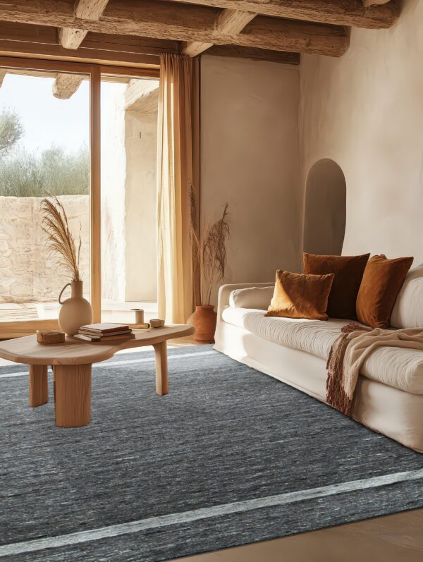A striated charcoal rug with a light stripe fills a sunny living room featuring exposed wood beams.