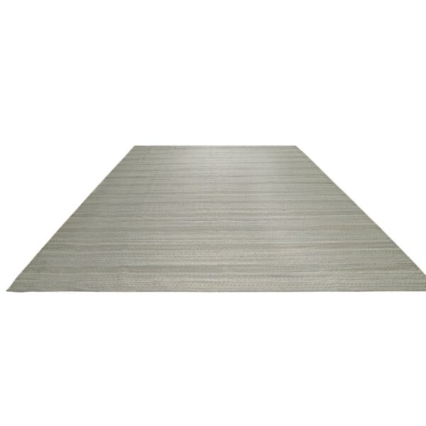 Pale gray flat woven rug featuring alternating horizontal stripes and subtle geometric patterns.