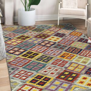 Multicolored flatweave rug featuring vibrant geometric diamond shapes on light wood flooring in a corner setting.