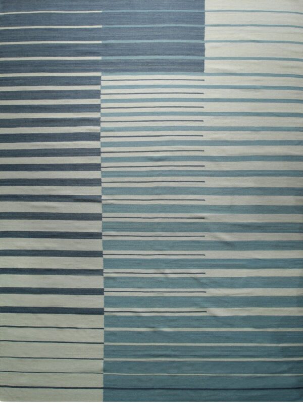 The rug features geometric horizontal stripes in dark blue, aqua, and off-white color blocks.