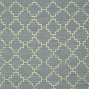 A low-pile blue rug features a repeating cream-colored geometric pattern of interlocking stepped diamonds.