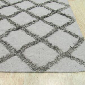 Textured gray rug with a high-pile trellis pattern displayed on light wood flooring.