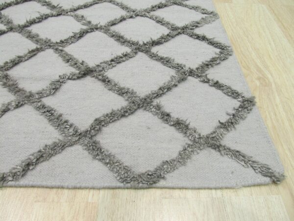 Textured gray rug with a high-pile trellis pattern displayed on light wood flooring.