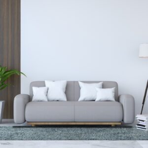 A textured teal and gray low-pile rug is beneath a light gray sofa on glossy white marble tile.