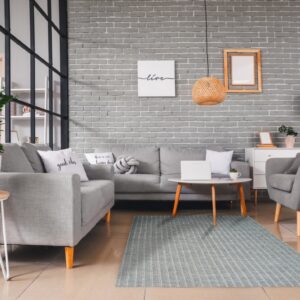 Low-pile blue-gray rug featuring narrow white vertical stripes in a modern gray living room setting.
