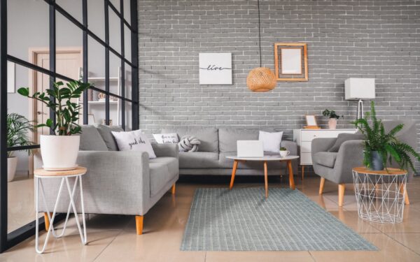 Low-pile blue-gray rug featuring narrow white vertical stripes in a modern gray living room setting.