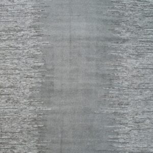 Gray rug with a dense center transitioning to textured white and dark gray horizontal streaking sides.