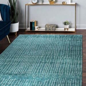 Teal rug featuring an abstract white linear pattern on dark wood floors with surrounding modern furniture.