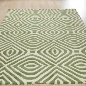 Textured green and off-white rug displaying concentric geometric diamond shapes on light wood flooring.
