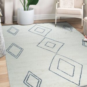 Light cream rug featuring large dark blue diamond outlines placed beneath a chair and plant.