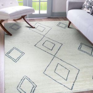 Ivory textured rug featuring scattered navy outlined diamonds, set beneath a white chair and gray sofa.