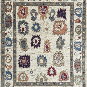 Textured off-white rug with a gray border framing spaced red, blue, and rust stylized tribal patterns.