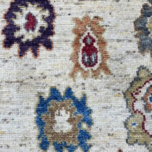 Textured cream rug with traditional multicolored medallions in purple, blue, red, and orange tones.