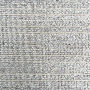 Gray and cream textured rug showing raised horizontal bands and bouclé-like spotted details.