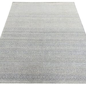 Light gray and cream striped rug with a textured surface and repeating geometric motifs.