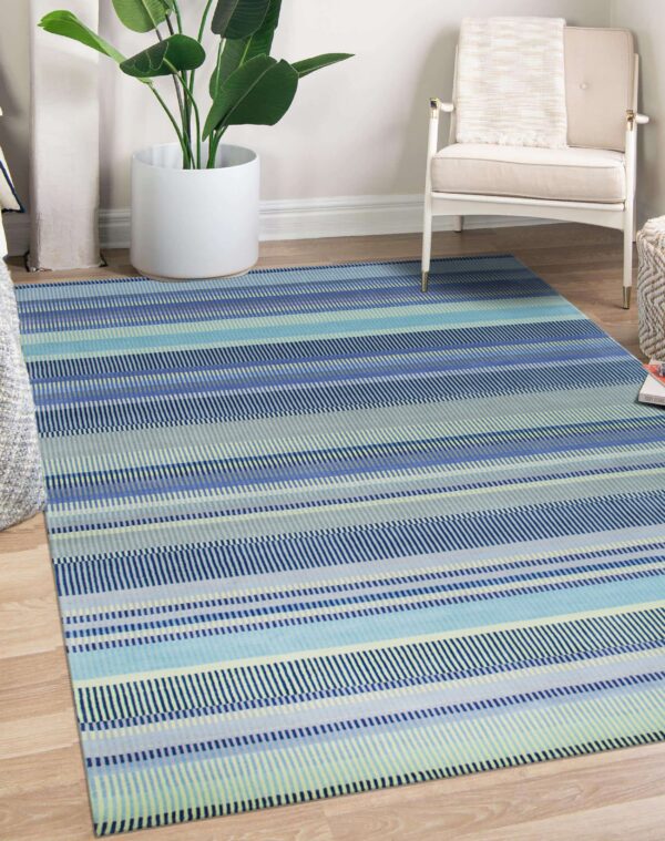 Blue, pale blue, and light green striped rug featuring a fine dash pattern on hardwood floors.