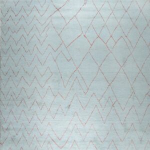 Light blue rug with reddish zigzag and diamond geometric patterns and visible white fringe edges.