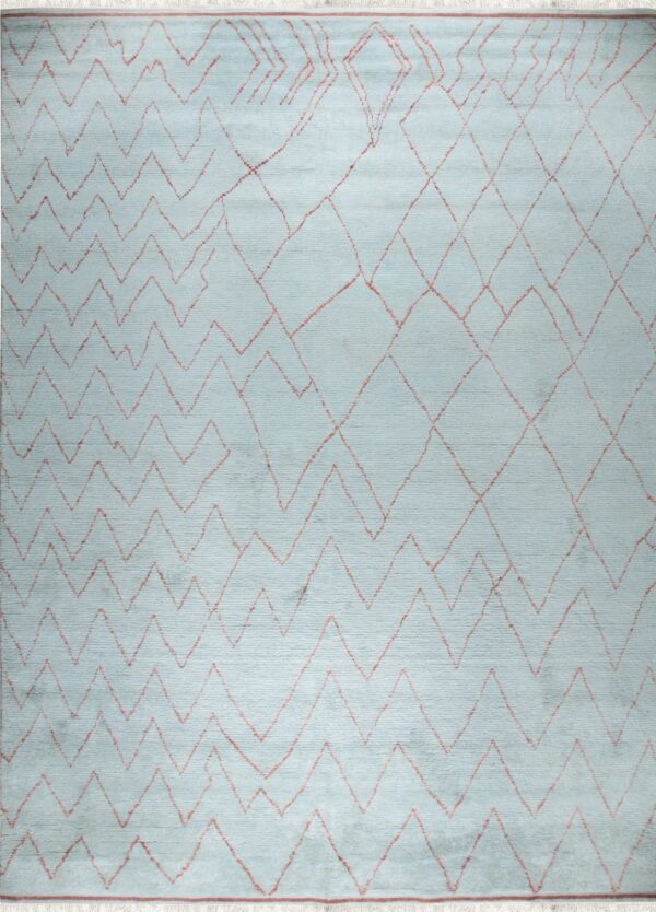 Light blue rug with reddish zigzag and diamond geometric patterns and visible white fringe edges.