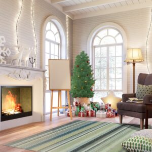 A diagonally striped green, teal, and gray low-pile rug sits on a wood floor in a festive room with a fireplace.