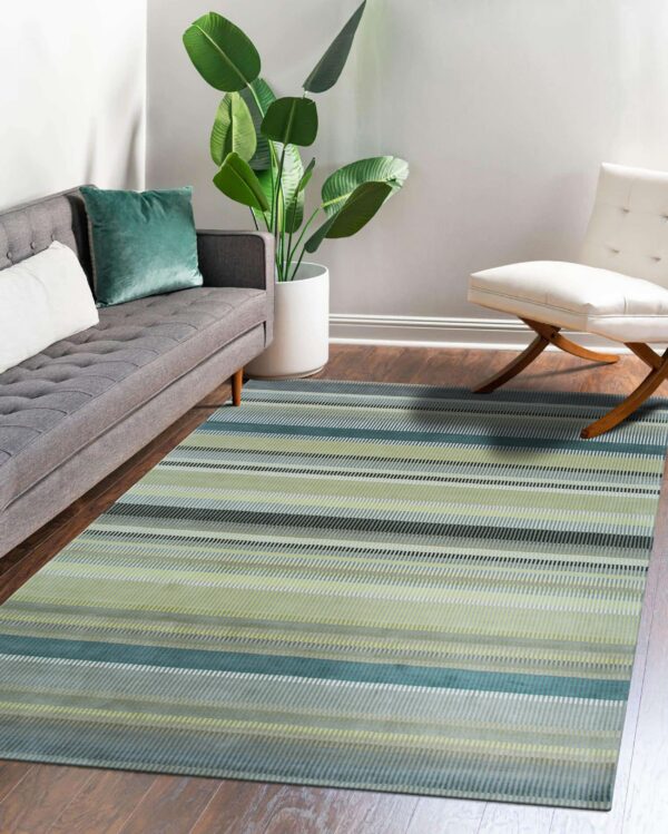 Green, teal, and gray striped rug in a living room with a gray sofa and hardwood floor.