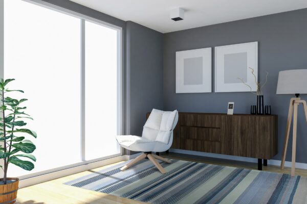 Thinly striped rug in varying shades of blue, gray, and beige on a light hardwood floor.
