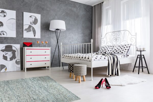 Blue and gray distressed rug and a white shaggy accent rug in a modern bedroom.