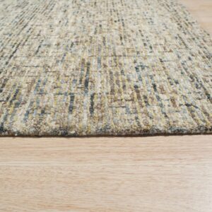 Textured area rug featuring mixed beige, yellow, and blue yarns in vertical bands on wood flooring.
