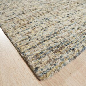 Textured loop rug featuring a subtle multicolored linear pattern in beige, blue, and yellow on light wood floors.